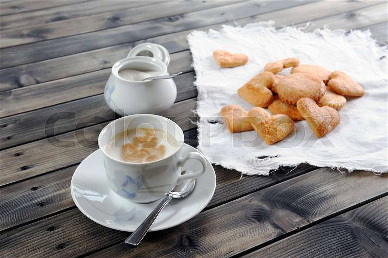 Foods of the Italian breakfast with coffee milk and biscuits on an old wooden table, stock photo