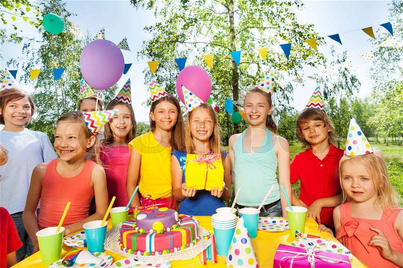 Big happy kid\'s company celebrating Birthday outdoor in the summer park, stock photo