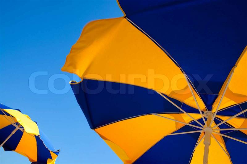 Beach umbrellas on a sunny day with a clear blue sky, stock photo