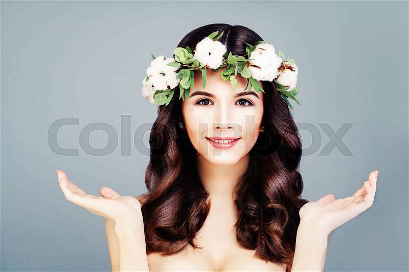 Beautiful Model Woman Showing her Opening Hands. Healthy skin and Wavy Hair, stock photo