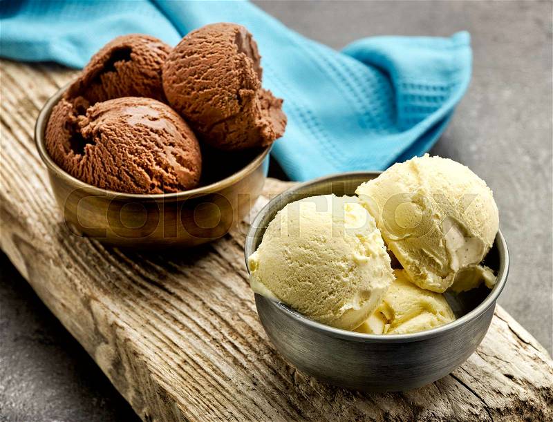 Vanilla and chocolate ice cream on wooden board, stock photo