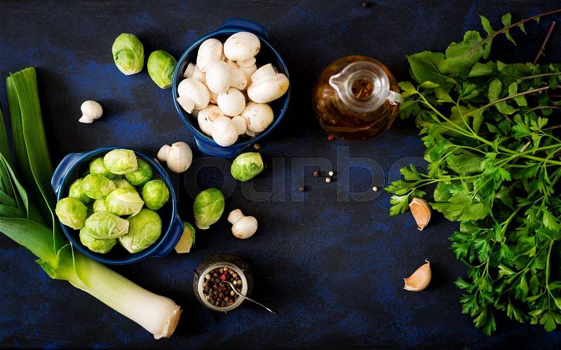 Dietary menu. Ingredients: Vegetables - Brussels sprouts, mushrooms, leeks and herbs on a dark background. Top view. Vegetables menu, stock photo