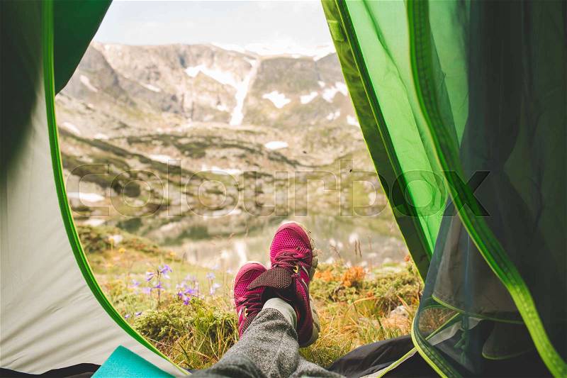 View from tourist tent inside on the mountain landscape. woman at the mountains, stock photo
