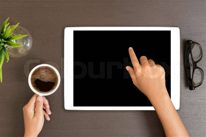 Hand use white tablet on desk table top view, stock photo