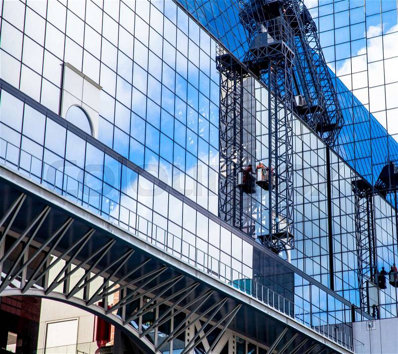 A man cleaning windows at Kyoto Station,It on a high rise building, stock photo
