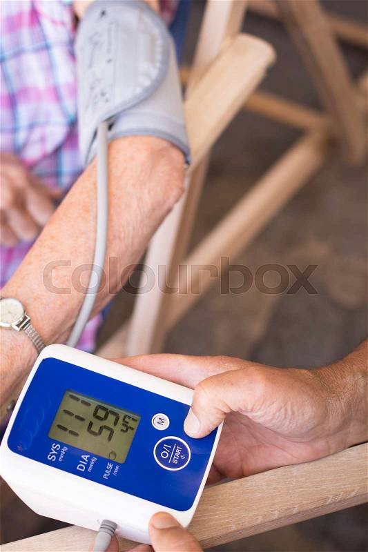 Cardiac blood pressure and irregular heart beat pulse rate meter to show resting heart rate in monitored old aged female patient, stock photo