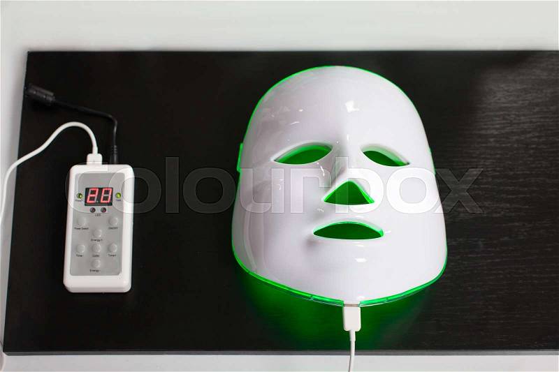 Light photodynamic rejuvenating mask for facial skin therapy, stock photo