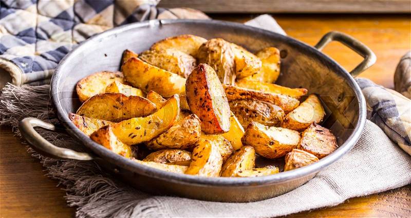 Potato. Roasted potatoes. American potatoes with salt pepper and cumin. Roasted potato wedges delicious crispy, stock photo