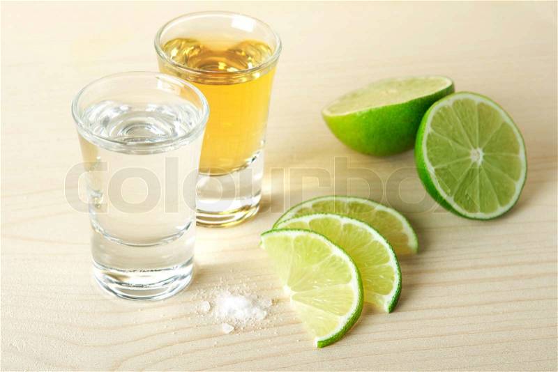 Blanc and Gold Tequila with lime and salt on wood table isolated on white background, stock photo