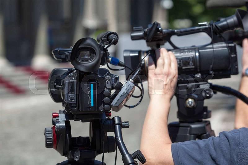 Covering an media event with a television camera, stock photo