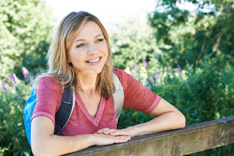 Portrait Of Mature Woman Hiking In Countryside, stock photo