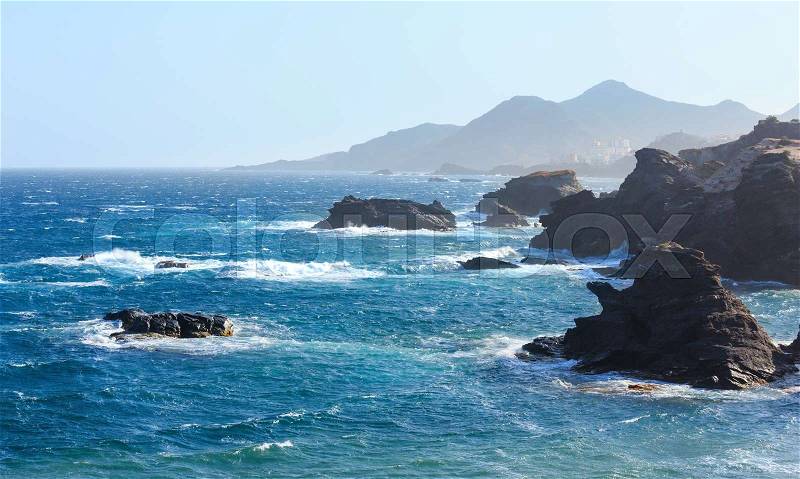 Atlantic ocean rocky coast scenery (misty stormy weather). Costa Blanca, Spain, stock photo