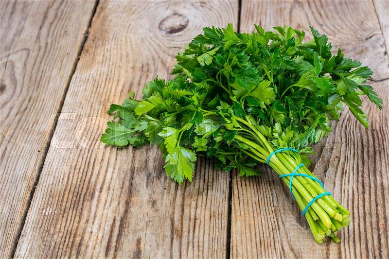 Fresh green bunch of parsley on the old board. Studio Photo, stock photo