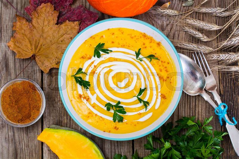 Spicy pumpkin carrot soup with pumpkin seeds and curry and fresh herbs. Studio Photo , stock photo