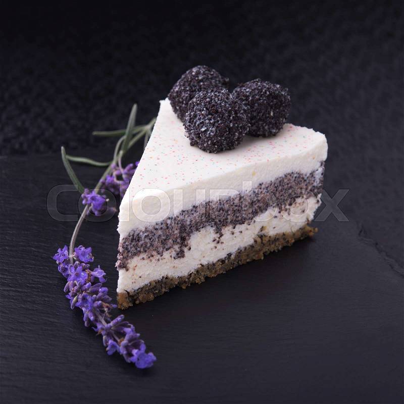 Unusual lavender flower cake sliced on stone slate. restaurant food, stock photo