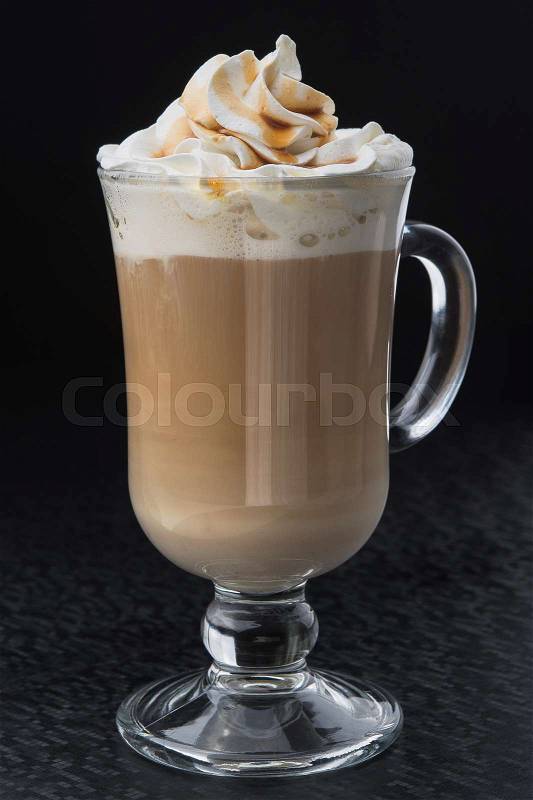 Glass of cup coffee with cream on black table, stock photo