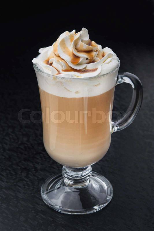 Glass of cup coffee with cream on black table, stock photo