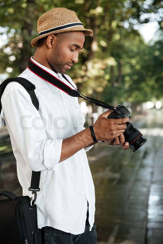 Close up fashion black man in park. with camera, stock photo