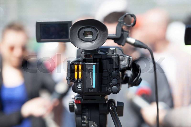 Filming an event with a video camera. TV broadcasting, stock photo