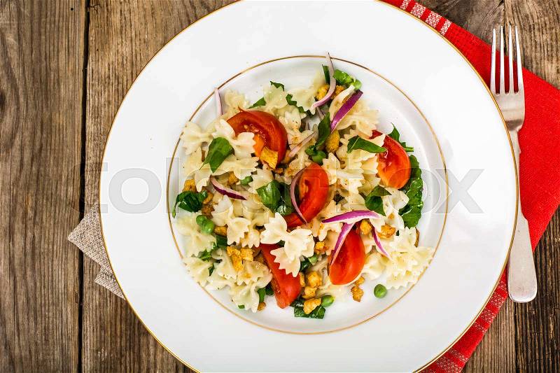 Pasta Salad with Arugula, Chicken, Peas, Onion and Tomato Studio Photo, stock photo