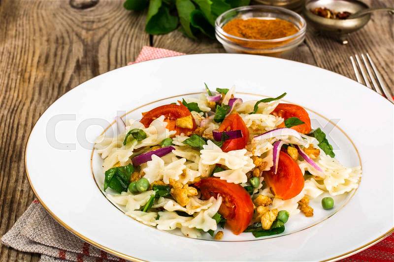 Pasta Salad with Arugula, Chicken, Peas, Onion and Tomato Studio Photo, stock photo