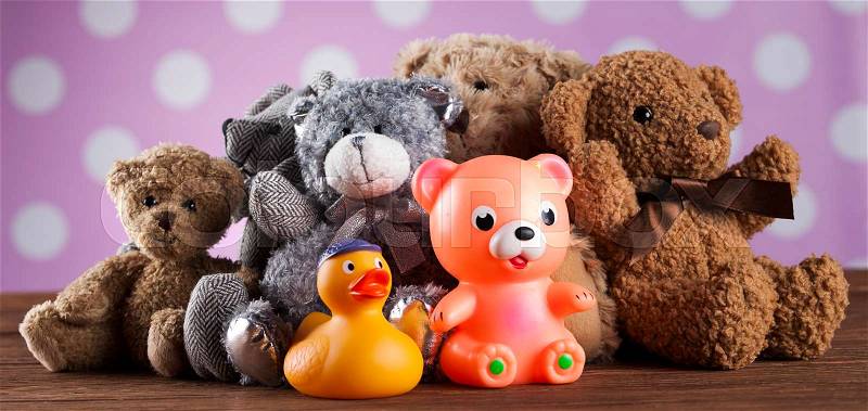 Cute teddy bears on wooden background, stock photo