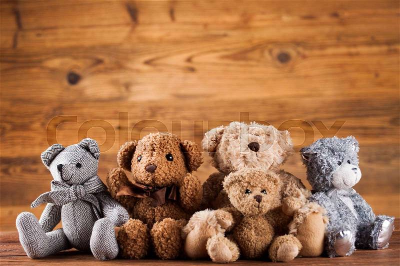 Cute teddy bears on wooden background, stock photo