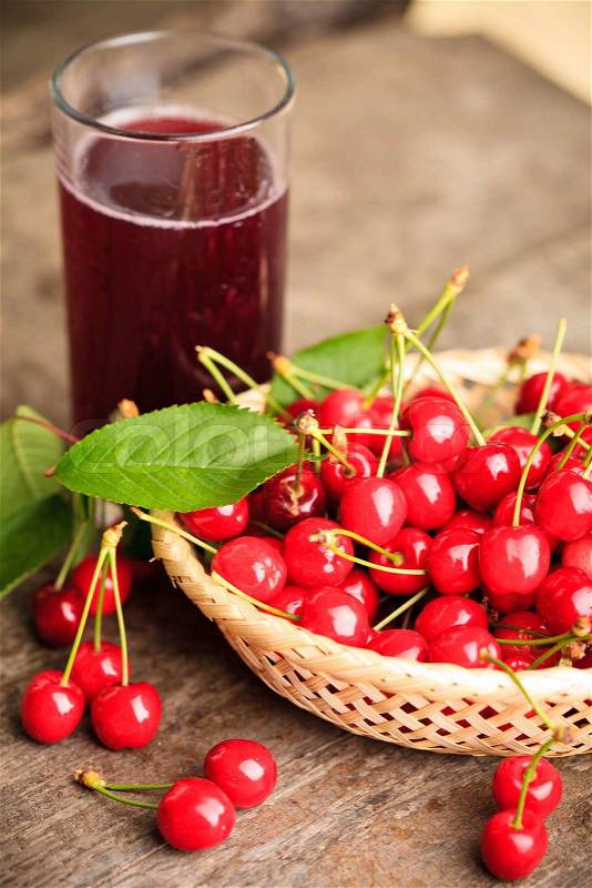 Sweet cherries in basket outdoor and glass, stock photo