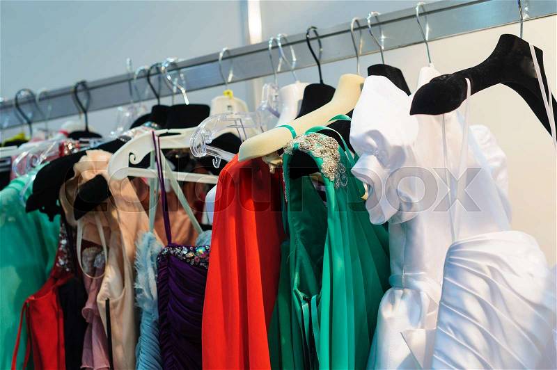 Womans dresses on hangers in store for sale, stock photo