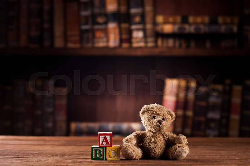 Teddy bear on on vintage wooden background, stock photo