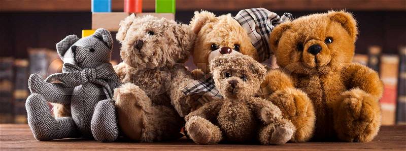 Group of cute teddy bears on vintage wooden background, stock photo