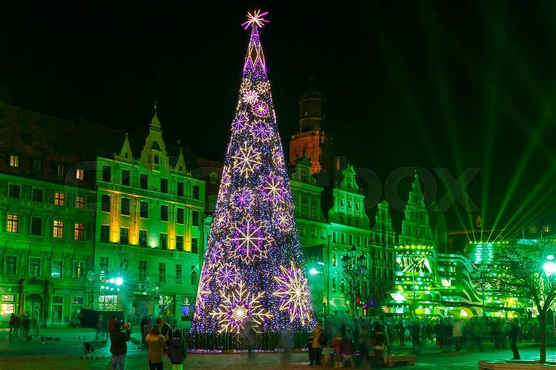 Christmas tree and light laser show on Market Square at christmas night in Wroclaw, Poland, stock photo
