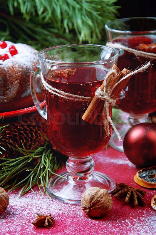 Christmas table setting. Bundt cake sprinkled with sugar powder decorated with red currant and mulled wine, stock photo