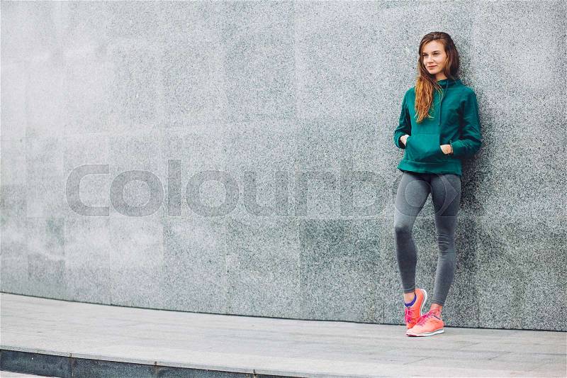 Fitness sport girl in fashion sportswear doing yoga fitness exercise in the street, outdoor sports, urban style, stock photo