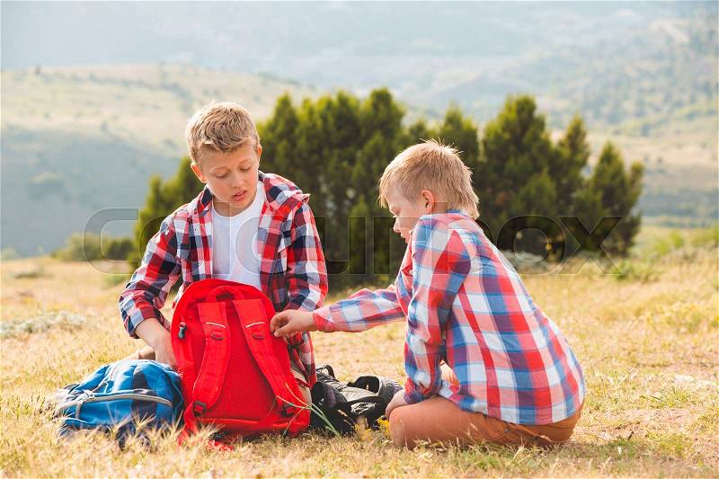 Two brothers walking in mountains near the sea, stock photo