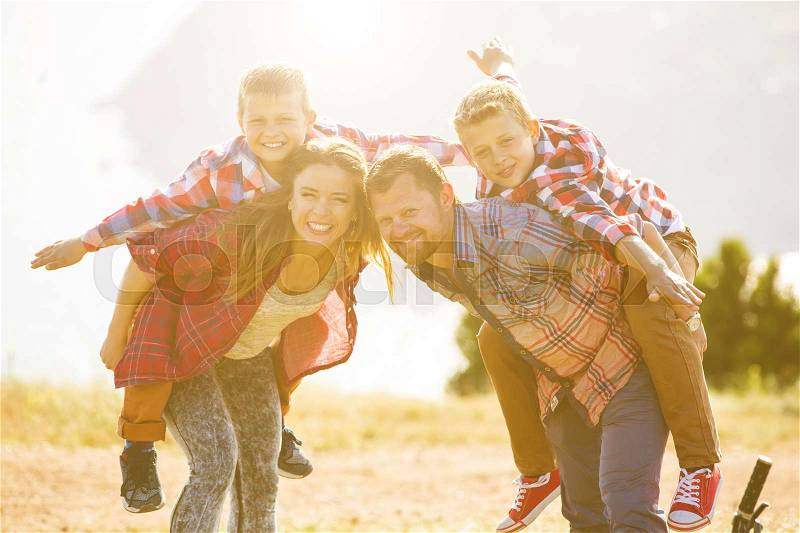 Family concept. happy family of four people riding bikes at the mountain, stock photo