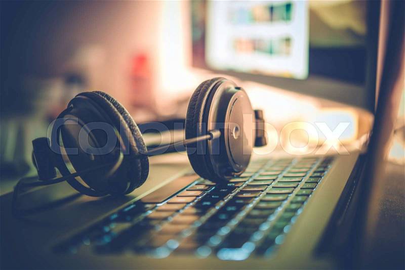 Digital Music Creation Theme with Professional Headphones on the Computer Keyboard, stock photo