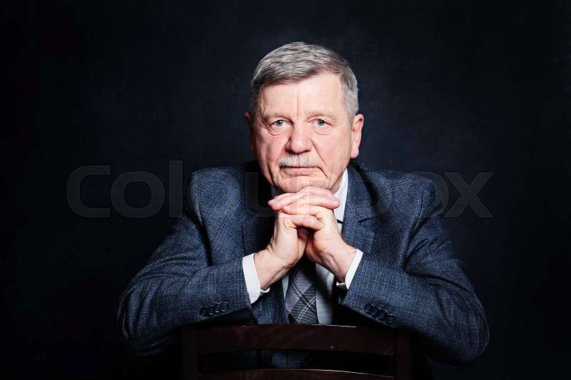 Confident Mature Businessman in a Suit. Senior Man on Black Background, stock photo
