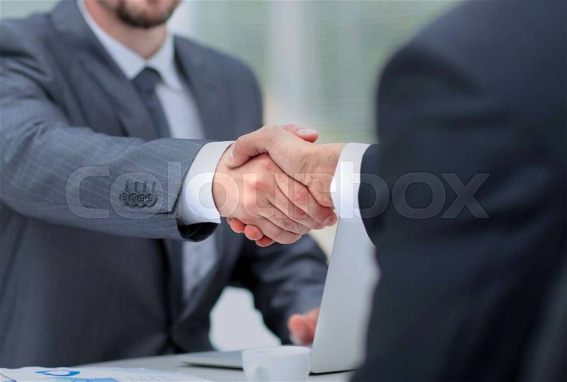 Closeup of a business handshake. Business people shaking hands, finishing up a meeting, stock photo