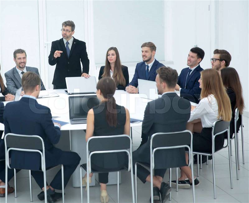 Businesspeople Sitting At Conference Round Table At The Meeting, stock photo