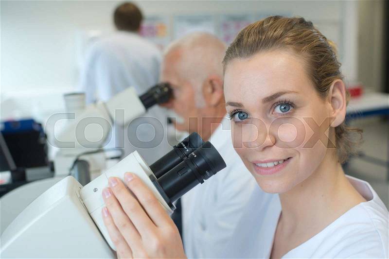 Portrait of a female scientist with microscope, stock photo
