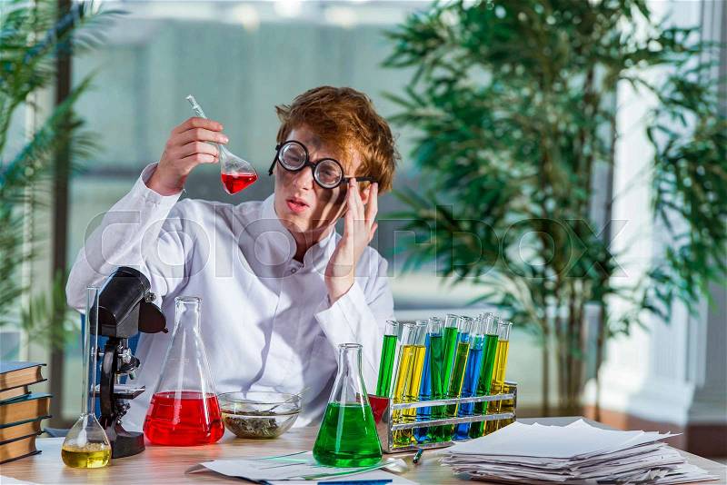 Young crazy chemist working in the lab, stock photo