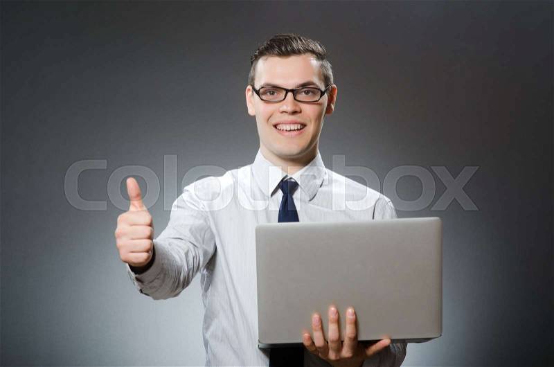 Man with laptop and thumbs up, stock photo