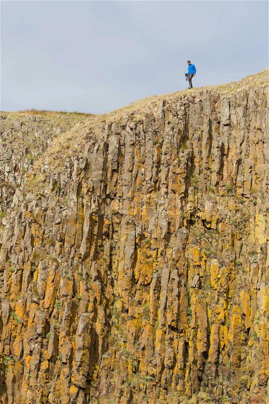 Man on the edge of the cliff - Westcoast of Iceland, stock photo