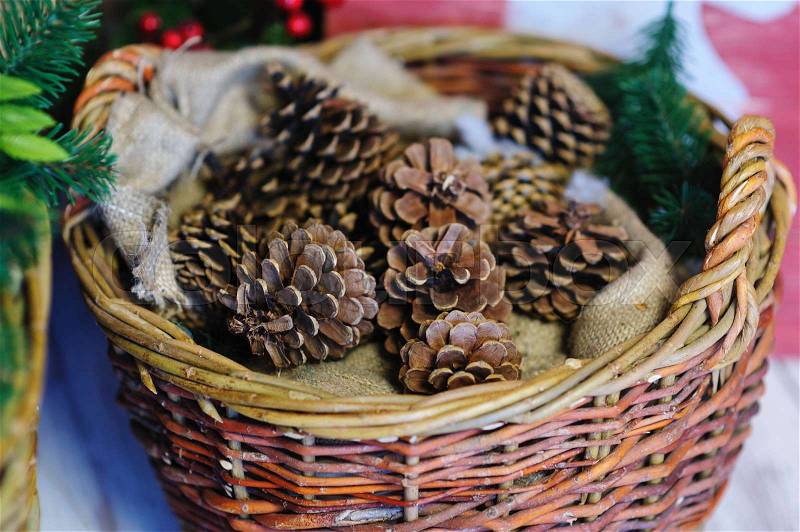 Pine cones in a basket. Christmas Decor, stock photo