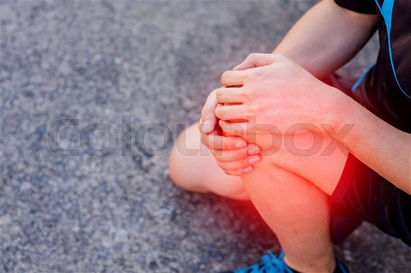 Runner touching painful knee. Athlete runner training accident. Sport running knee sprain. , stock photo