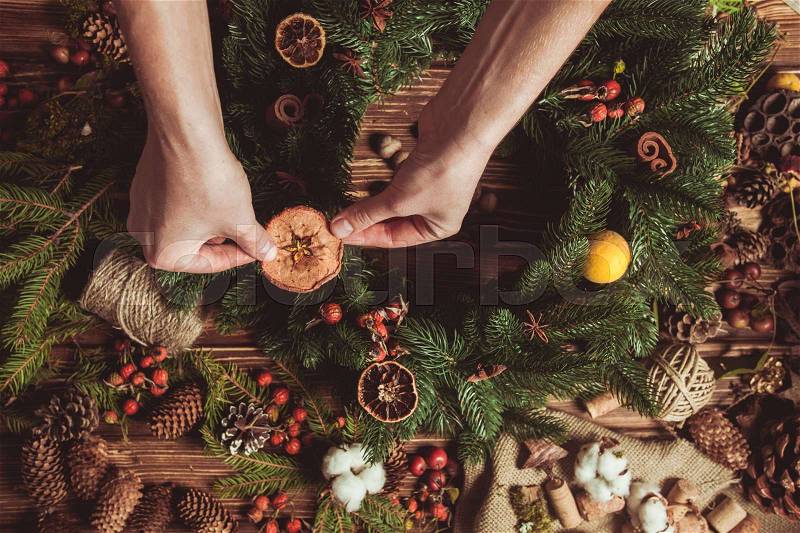 Nature components wreath - preparation for making natural eco decorations. Focus on hands, stock photo