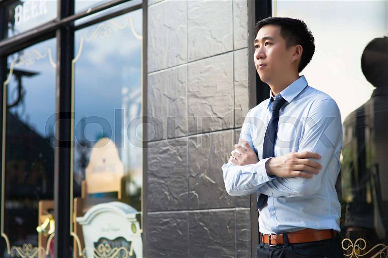 Asian Man Waiting for Loved one to arrive, stock photo