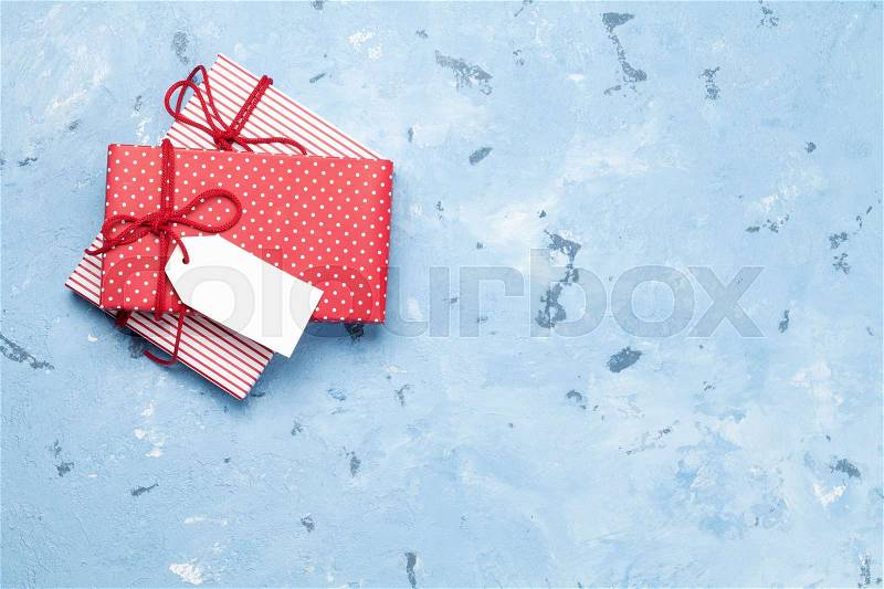 Christmas gift boxes on stone table. Top view with copy space, stock photo