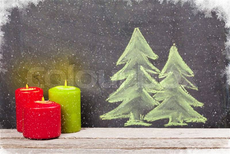 Christmas candles and hand drawn xmas fir tree with snow, stock photo